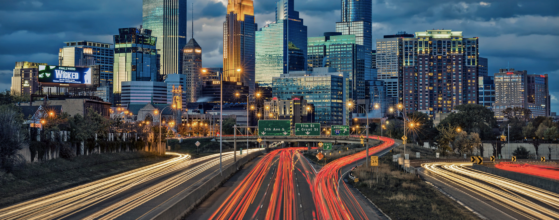 The downtown Minneapolis skyline viewed from the highway, the city newcomers explore while staying at Oaklands on 9th.