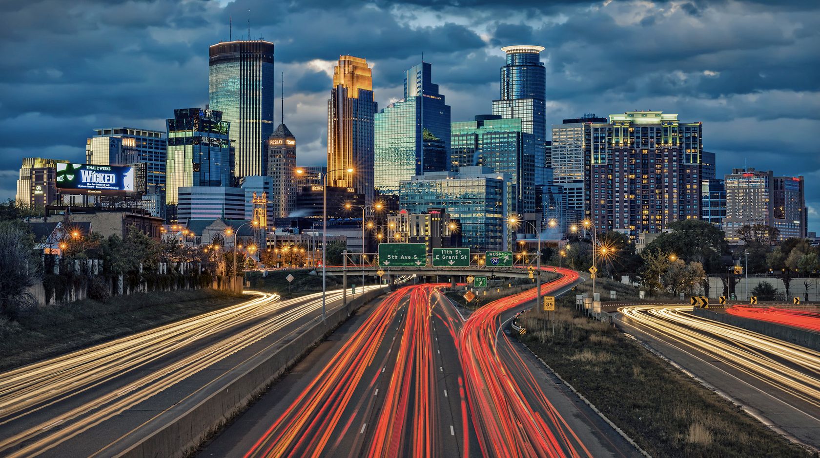 The downtown Minneapolis skyline viewed from the highway, the city newcomers explore while staying at Oaklands on 9th.