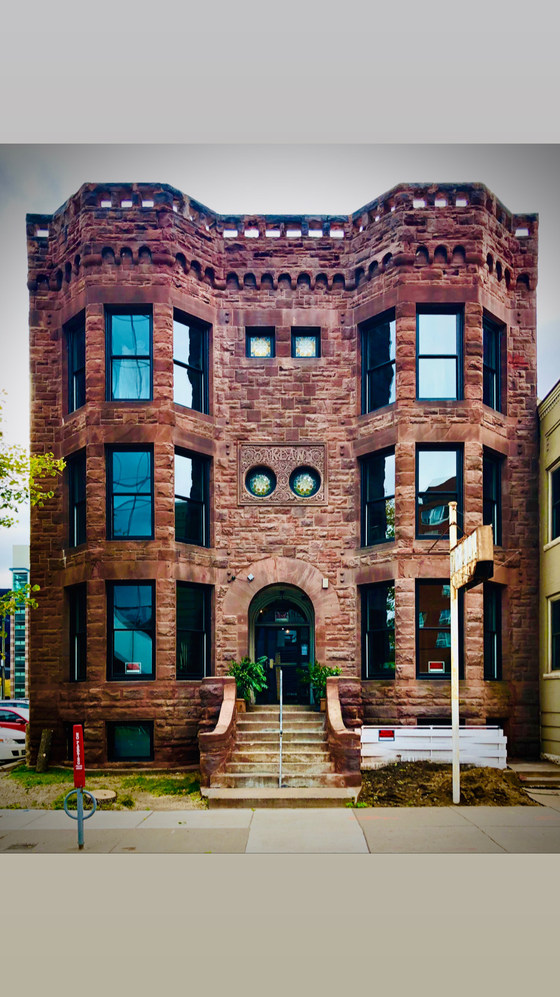 The restored 1889 brownstone facade of Oakland's on 9th on South 9th Street in downtown Minneapolis, with its arched entry and rows of tall windows
