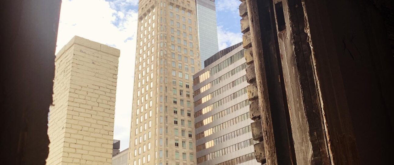 Downtown Minneapolis and the Foshay Tower framed through a restored historic window at Oaklands on 9th