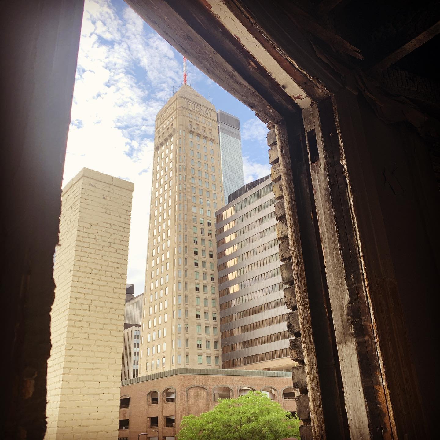 Downtown Minneapolis and the Foshay Tower framed through a restored historic window at Oaklands on 9th