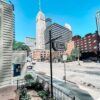The Oaklands on 9th garden patio with downtown Minneapolis high-rises rising behind it on a clear summer day