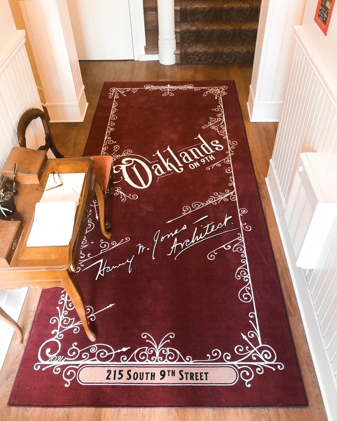 Entry mat inside Oaklands on 9th in Minneapolis signed 'Harry W. Jones, Architect' above the address 215 South 9th Street.