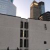 The Oaklands on 9th brownstone at dusk in downtown Minneapolis with the lit Foshay Tower glowing behind it