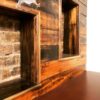 Two reclaimed-wood storage cubbies framing exposed original 1889 brick inside a restored Oaklands on 9th studio in downtown Minneapolis.
