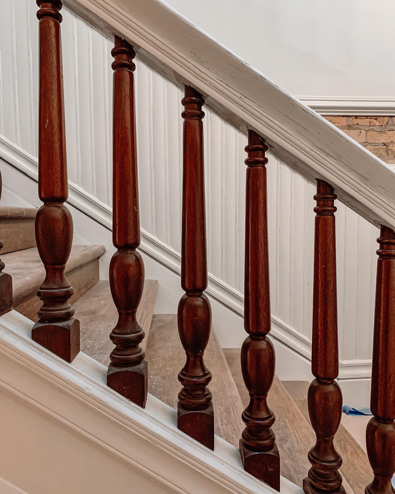 Restored Victorian wood balusters and treads on the grand staircase inside the 1889 Oaklands on 9th brownstone in downtown Minneapolis.