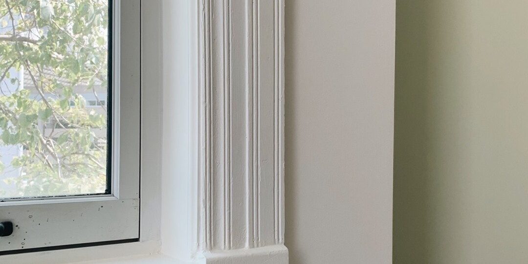 Restored 1889 painted window trim and woodwork inside a furnished studio at Oaklands on 9th