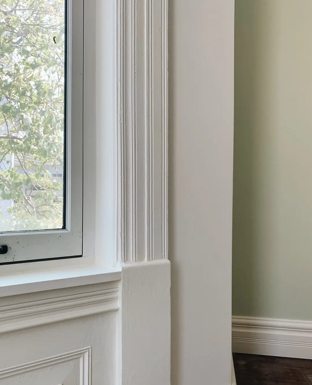 Restored 1889 painted window trim and woodwork inside a furnished studio at Oaklands on 9th