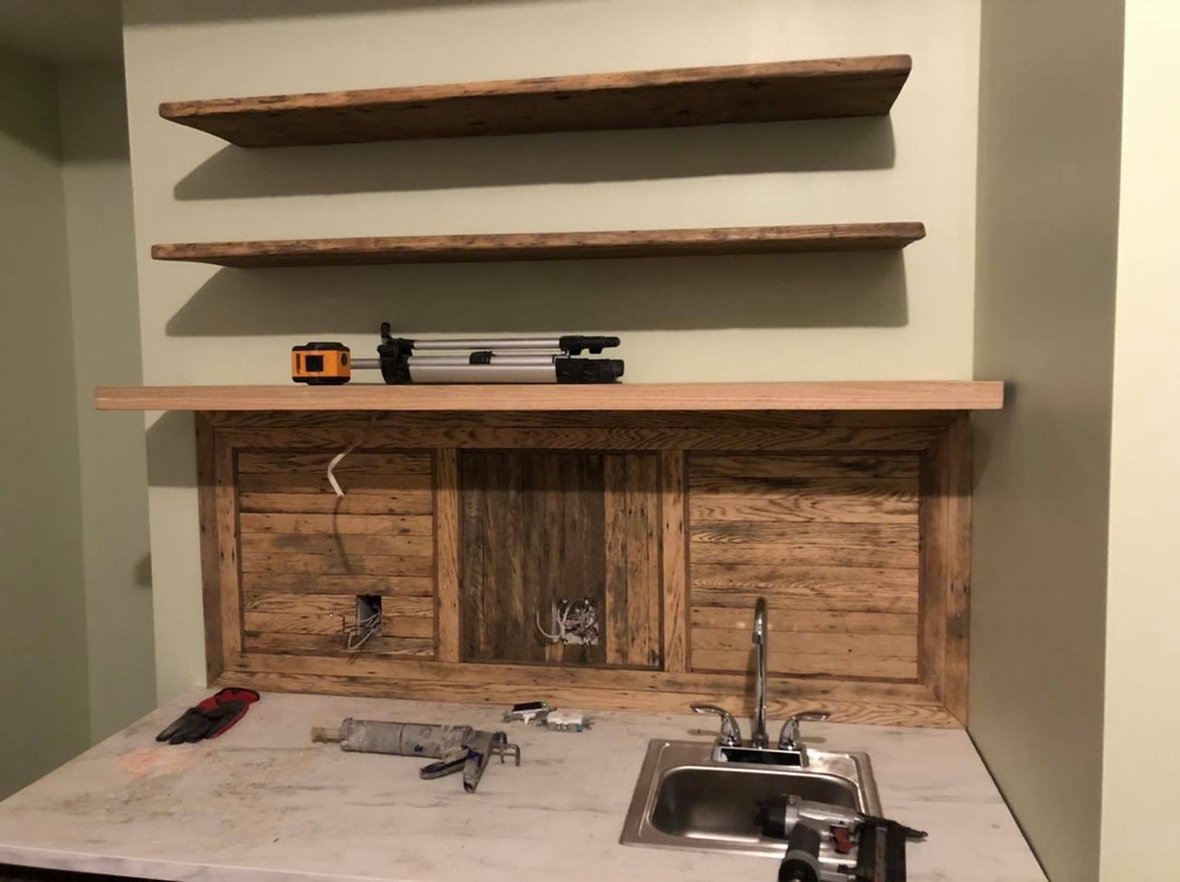 Studio kitchen at Oaklands on 9th with a backsplash and floating shelves built from the building’s own reclaimed oak flooring